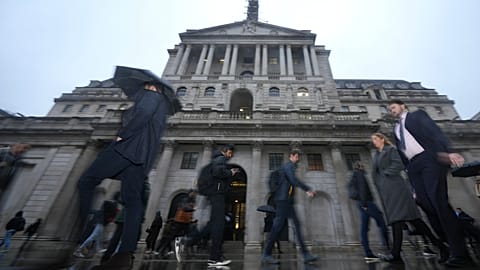 FILE - People walk in front of the Bank of England, at the financial district in London, 5 February 2026.