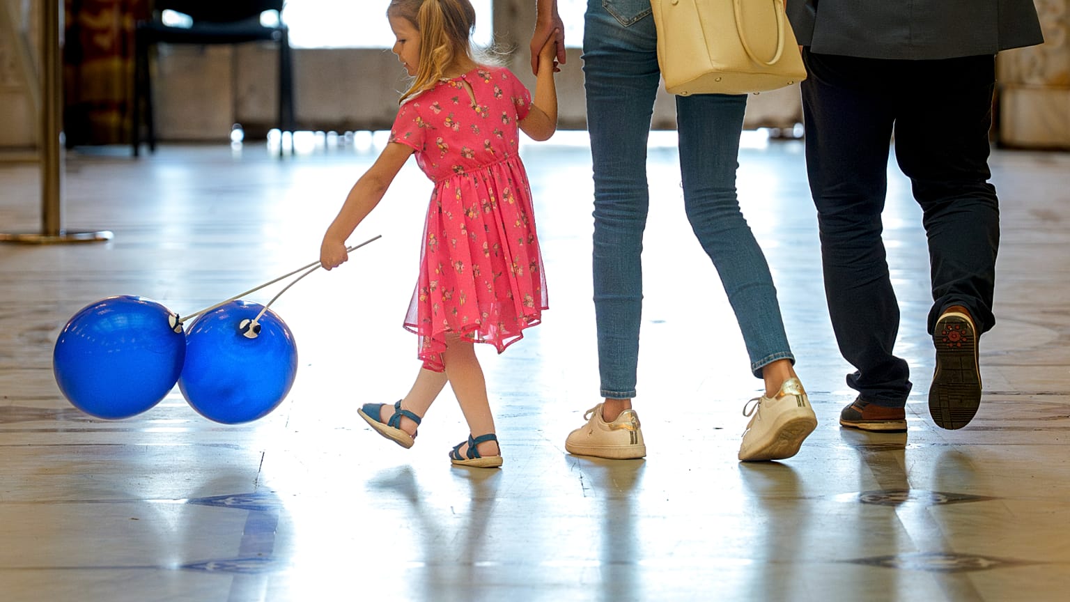 A child plays with balloons inside Romania's Palace of Parliament during a series of events marking International Children's Day in Bucharest, Romania, Sunday, June 1, 2025