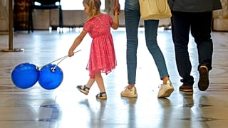 A child plays with balloons inside Romania's Palace of Parliament during a series of events marking International Children's Day in Bucharest, Romania, Sunday, June 1, 2025