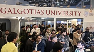 People visit Galgotias University stall at AI summit ahead of an eviction order issued by Indian authorities, in New Delhi, India, Wednesday, Feb. 18, 2026