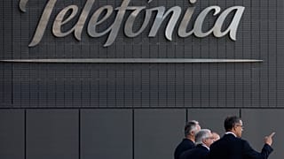 FILE. Men walk out of Telefónica head offices in Madrid, July 2013