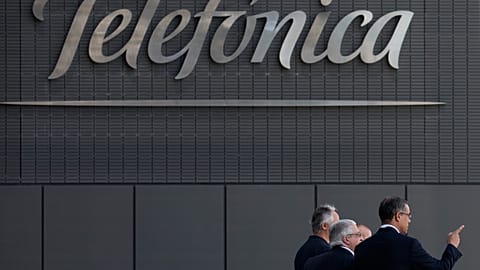 FILE. Men walk out of Telefónica head offices in Madrid, July 2013