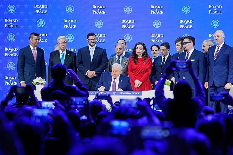US President Donald Trump signs the charter of his Board of Peace initiative at the Annual Meeting of the World Economic Forum in Davos, Switzerland, Thursday, Jan. 22, 2026. 