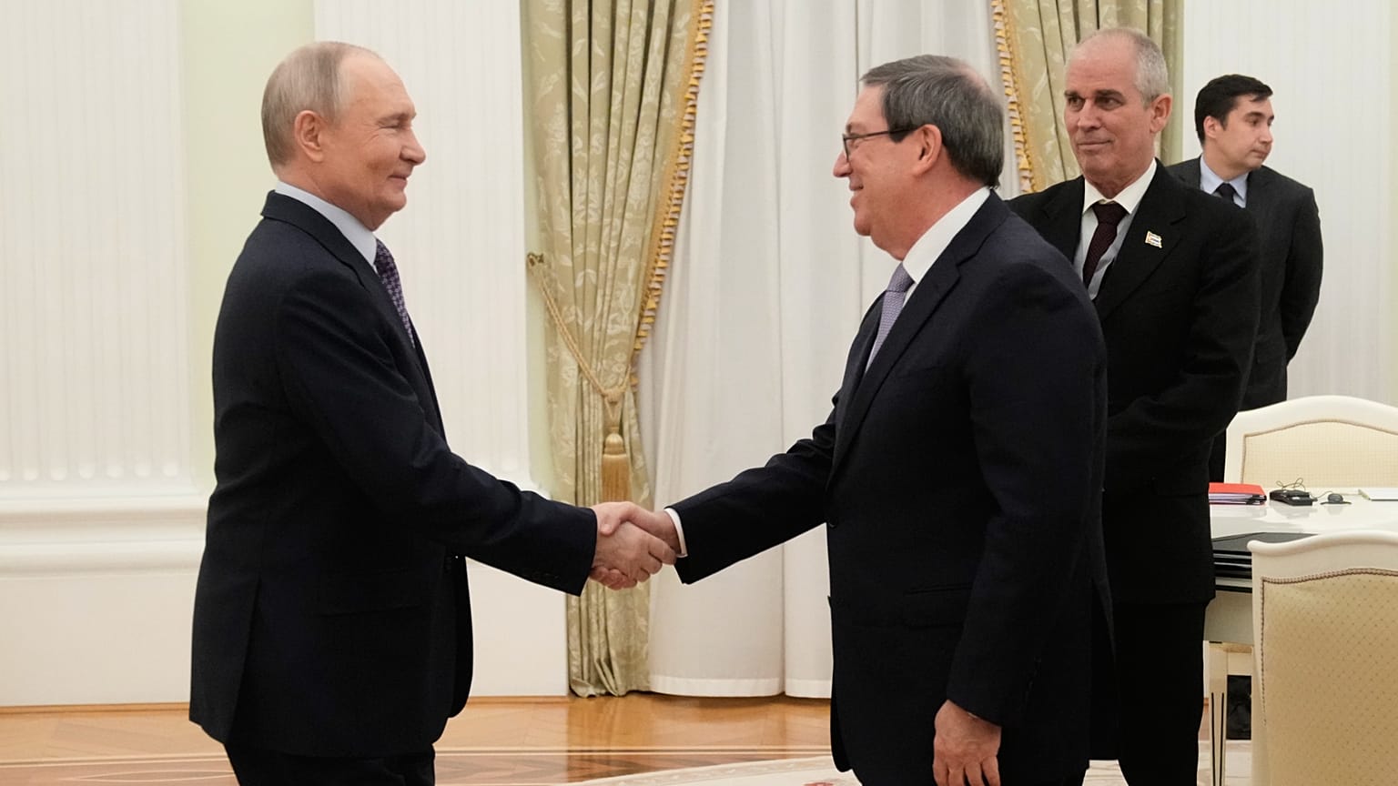 Russian President Vladimir Putin, left, shakes hands with Cuban Foreign Minister Bruno Rodriguez Parrilla during their meeting at the Senate Palace of the Kremlin in Moscow.
