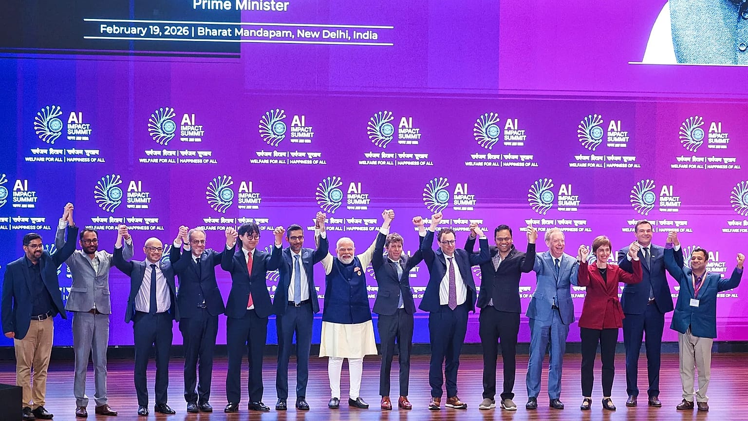 India's Prime Minister Narendra Modi, seventh left, poses for photographs with chief executive officers of various AI groups during the AI Summit in New Delhi, India, Thursday