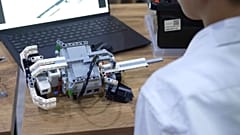 A student programs a robot during a robotics lesson in Uzbekistan