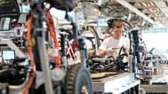 A Volkswagen employee checks an ID.3 electric car at the transparent factory in Dresden, Germany.