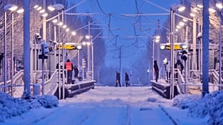 Öffentliche Mitarbeiter reinigen einen U-Bahn-Bahnsteig nach starkem Schneefall in der Nacht in Frankfurt, Deutschland, am Donnerstag, dem 19. Februar 2026