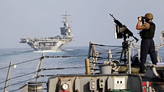 FILE: The aircraft carrier USS Dwight D Eisenhower and other warships cross the Strait of Hormuz into the Persian Gulf on Sunday, 26 November 2023