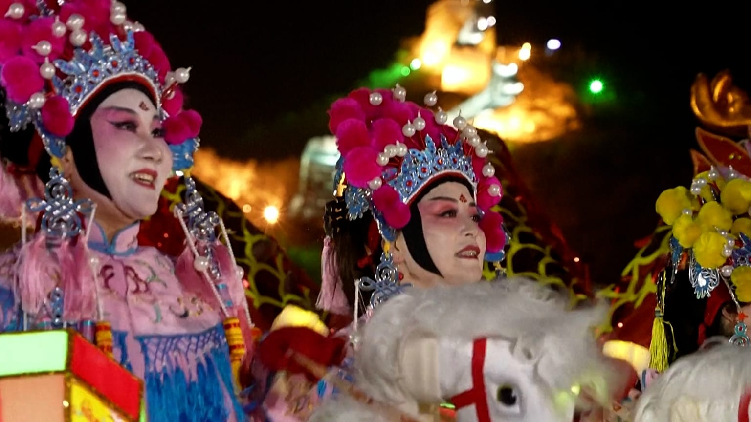 Women with traditional costumes and fake horses giving a performance at the Great Wall of China