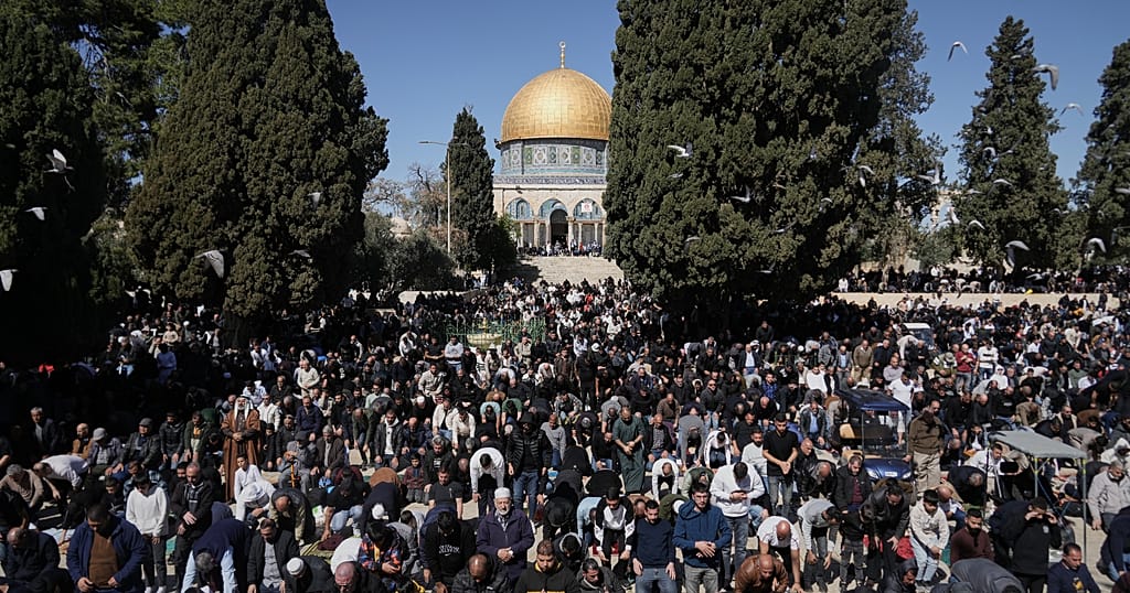 Palestinians wait at West Bank checkpoint to enter Jerusalem for Ramadan prayers