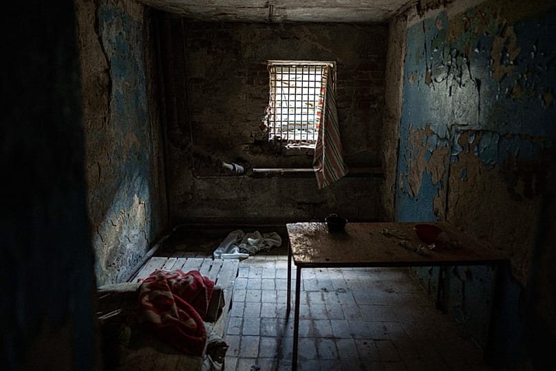 Bars cover a window of a room in a police department in Izium, Ukraine, Sept. 22, 2022. Ukrainian civilians said they were held and tortured by Russian soldiers