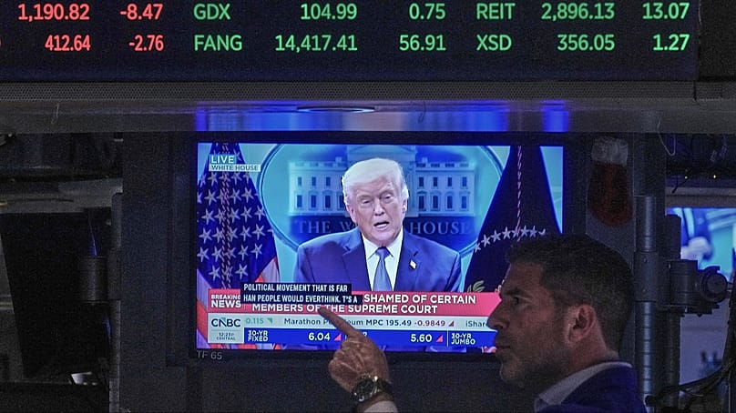 President Donald Trump appears on a trading post television screen on the floor of the New York Stock Exchange, 20 February 2026.