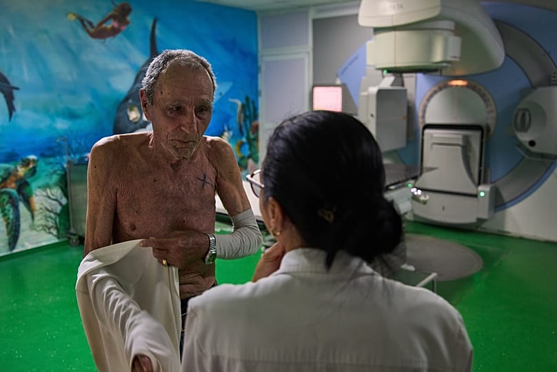 Jorge Elias speaks with the doctor after his radiotherapy session at the National Institute of Oncology and Radiology in Havana, Cuba, Friday, Feb. 20, 2026