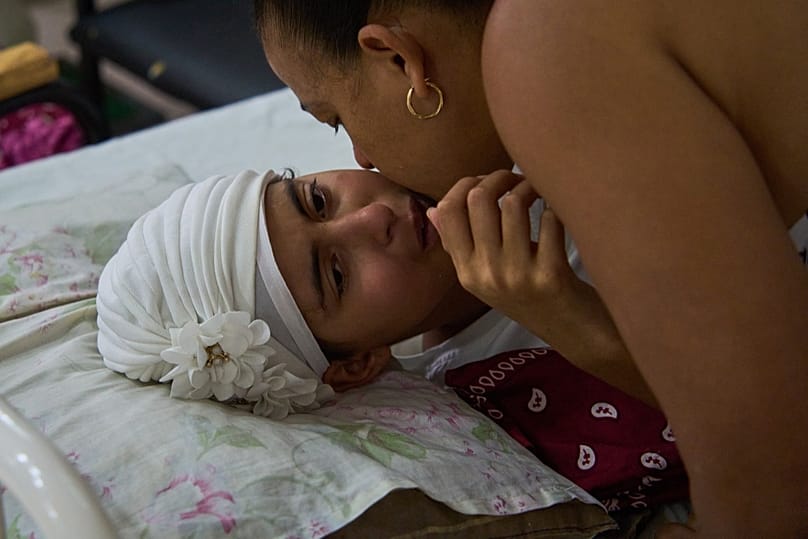 Niala Gonzalez, a cancer patient is kissed by her mother at the National Institute of Oncology and Radiology in Havana, Cuba, Friday, Feb. 20, 2026