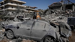 People gather near a building destroyed in an Israeli strike in the village of Bednayel in eastern Lebanon, Saturday, Feb. 21, 2026