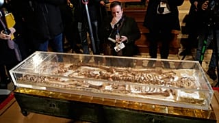 Journalists record the remains of Francis of Assisi inside the Basilica of St Francis of Assisi in Assisi, Italy 21 Feb 2026