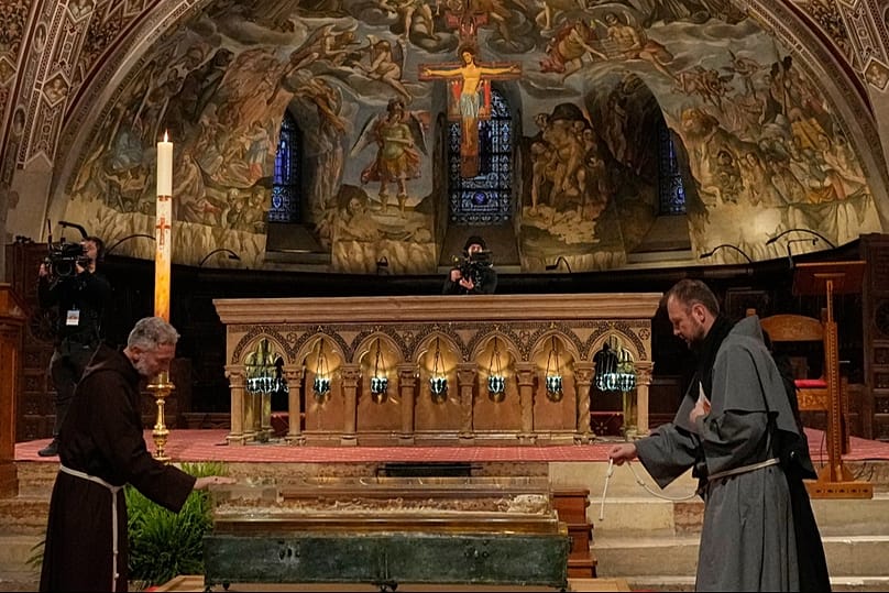 Friars pray before the remains of Francis of Assisi on the eve of the exhibition marking the 800th anniversary of his death, 21 Feb 2026
