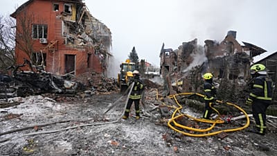 Firefighters put out a fire after a drone hit a residential building during a Russian air attack in Kyiv, Ukraine, Sunday, Feb. 22, 2026.