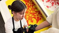 Lady doing tattoo