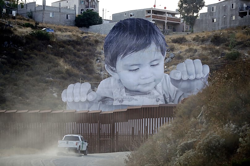 JR’s “Kikito” installation at the U.S.-Mexico border wall in Tecate, Mexico, September 2017.