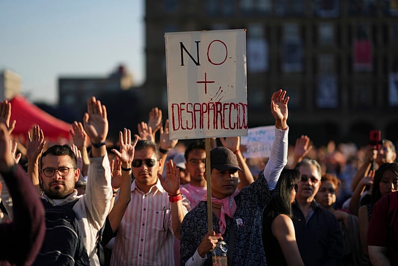 Demonstrators attend a vigil at the Zocalo, Mexico City's main square, 15 March 2025, for the victims whose skeletal remains were discovered at a ranch in Jalisco state. 