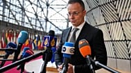 Hungary's Foreign Minister Peter Szijjarto speaks with the media as he arrives for a meeting of EU foreign ministers at the European Council building in Brussels, Monday, Feb.