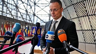 Hungary's Foreign Minister Peter Szijjarto speaks with the media as he arrives for a meeting of EU foreign ministers at the European Council building in Brussels, Monday, Feb.