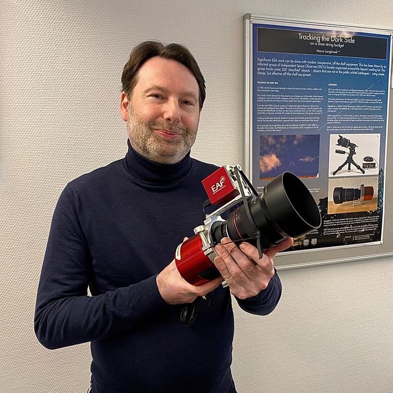 Marco Langbroek holding his camera to observe classified satellites