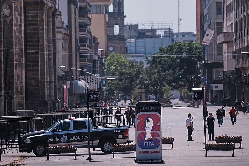 Police officers stand guard in downtown Guadalajara, Jalisco state, Mexico, Feb. 22, 2026, after the death of the leader of the Jalisco New Generation Cartel "El Mencho."