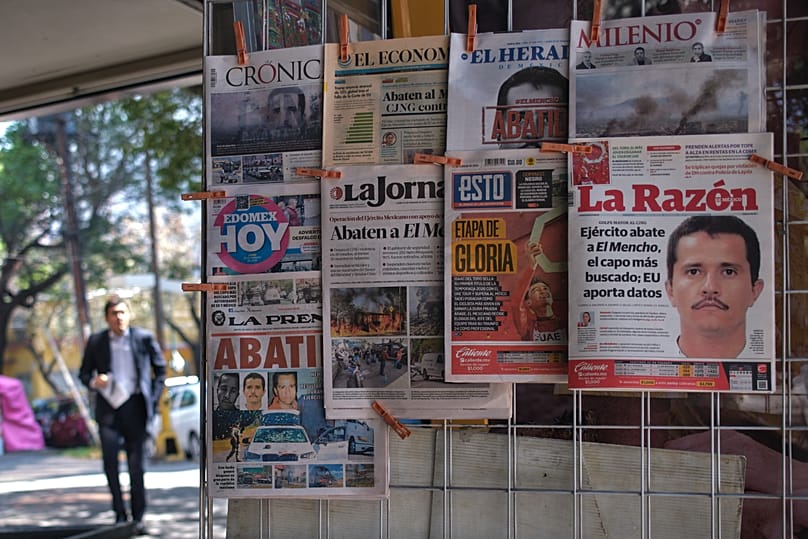 Newspapers hang on display for sale in Mexico City, Monday, Feb. 23, 2026, a day after the Mexican army killed Jalisco New Generation Cartel leader Nemesio Oseguera Cervantes.