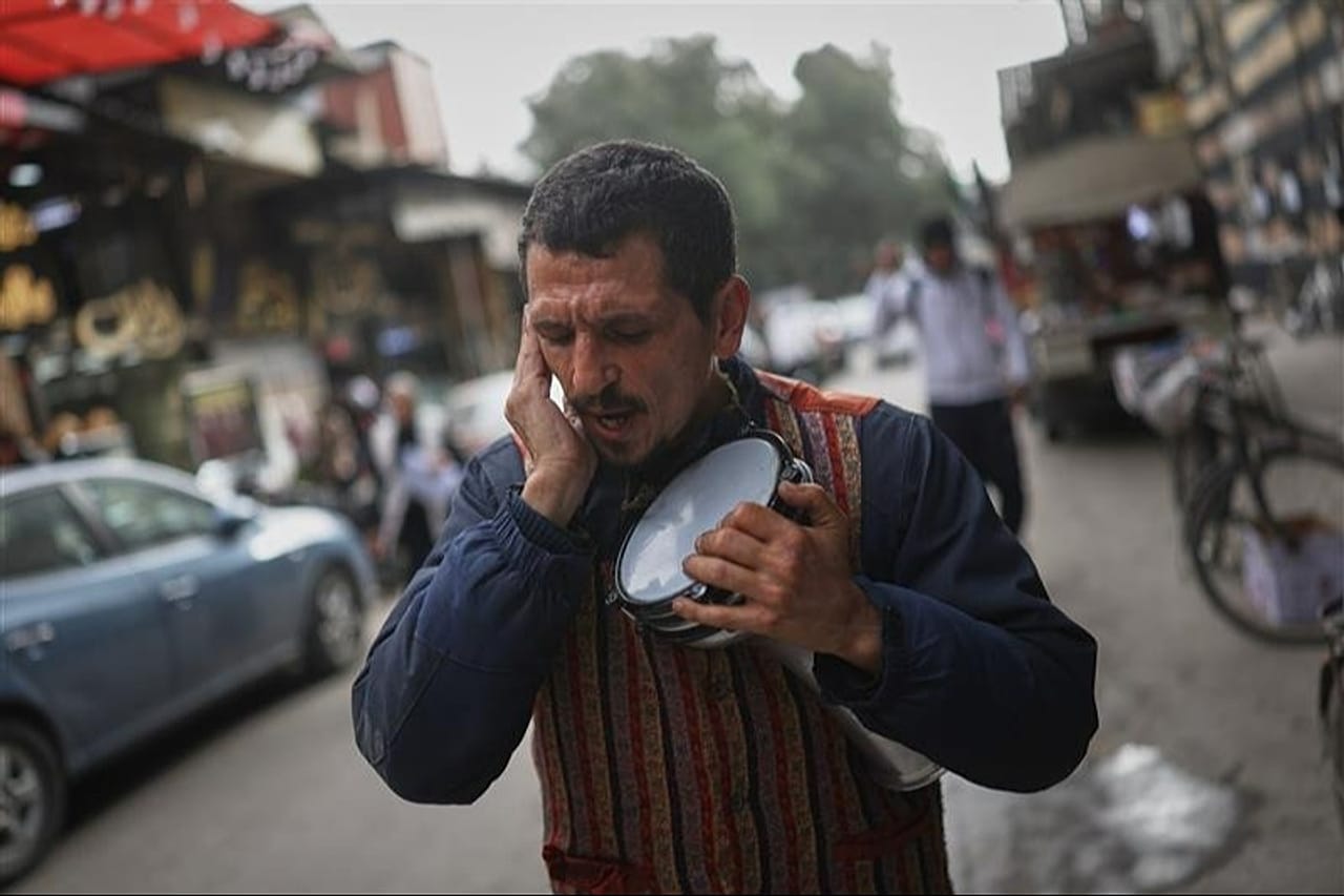 FILE: Man sings traditional Ramadan songs as residents prepare for the upcoming holy month of Ramadan at the Jazmatia Market in Damascus, 17 February 2026