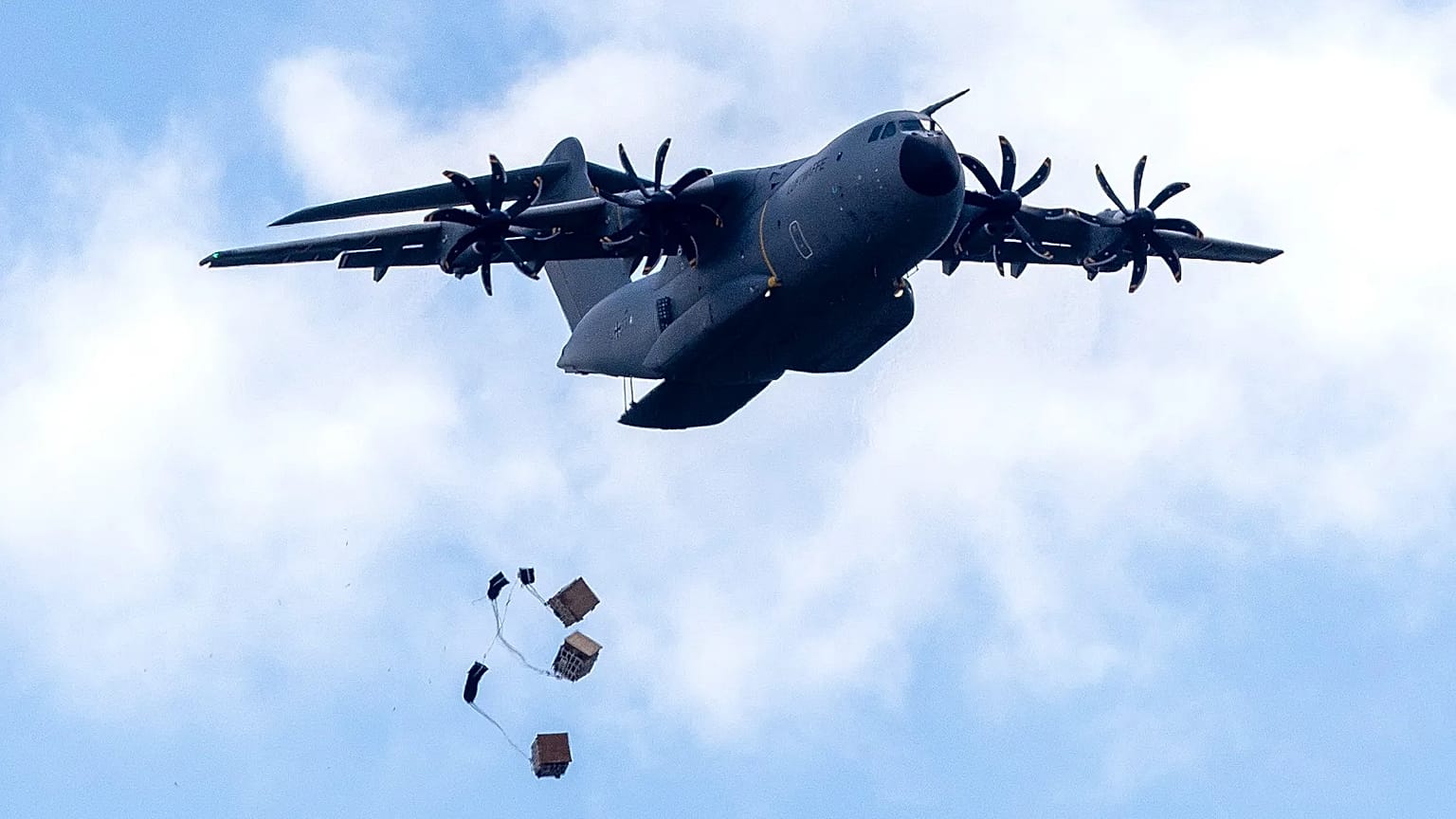 A Lockheed Martin C-130J-30 Super Hercules drops military equipment during a 'Swift Response 2025' military exercise