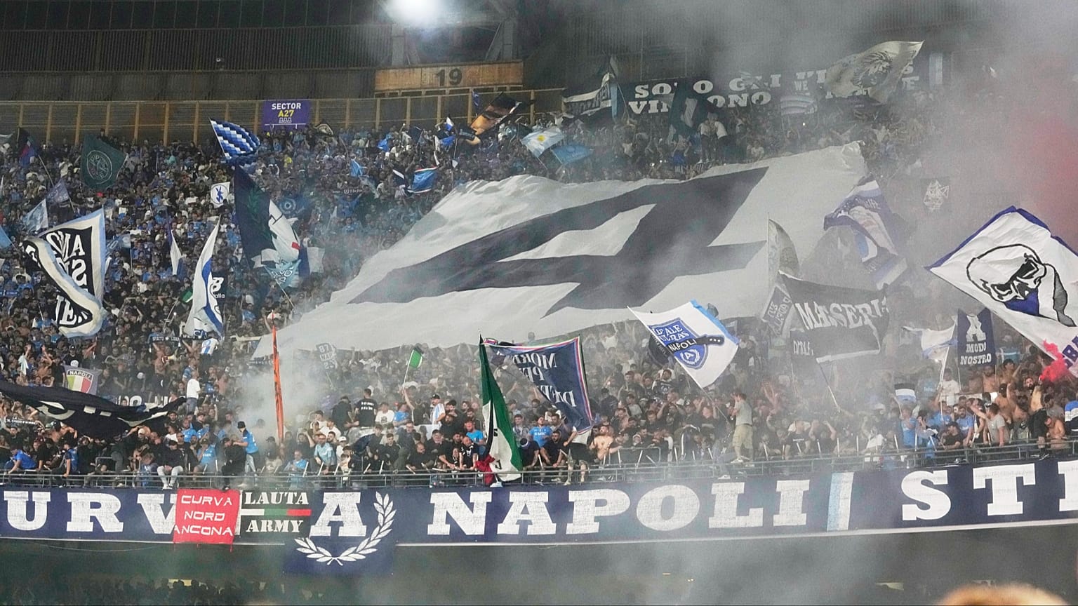 FILE: Fans celebrate showing a number 4 during the Italian Serie A football match between Napoli and Cagliari at the Diego Maradona stadium in Naples, Italy, May 23, 2025.