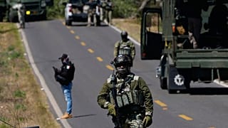 FILE: A soldier clears a roadblock on a road leading to Tapalpa, 23 February 2026