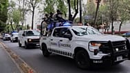 National Guards escort an ambulance to the General Prosecutor's headquarters in Mexico City on Sunday 22 February