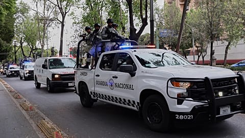 National Guards escort an ambulance to the General Prosecutor's headquarters in Mexico City on Sunday 22 February