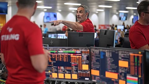 FILE. Brokers work on the trading floor at BGC Group, London, Sept. 2025