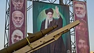 FILE: A domestically-built missile "Khaibar-buster," and banners showing portraits of the Iranian Supreme Leader Ayatollah Ali Khamenei, in Tehran, 25 September 2025