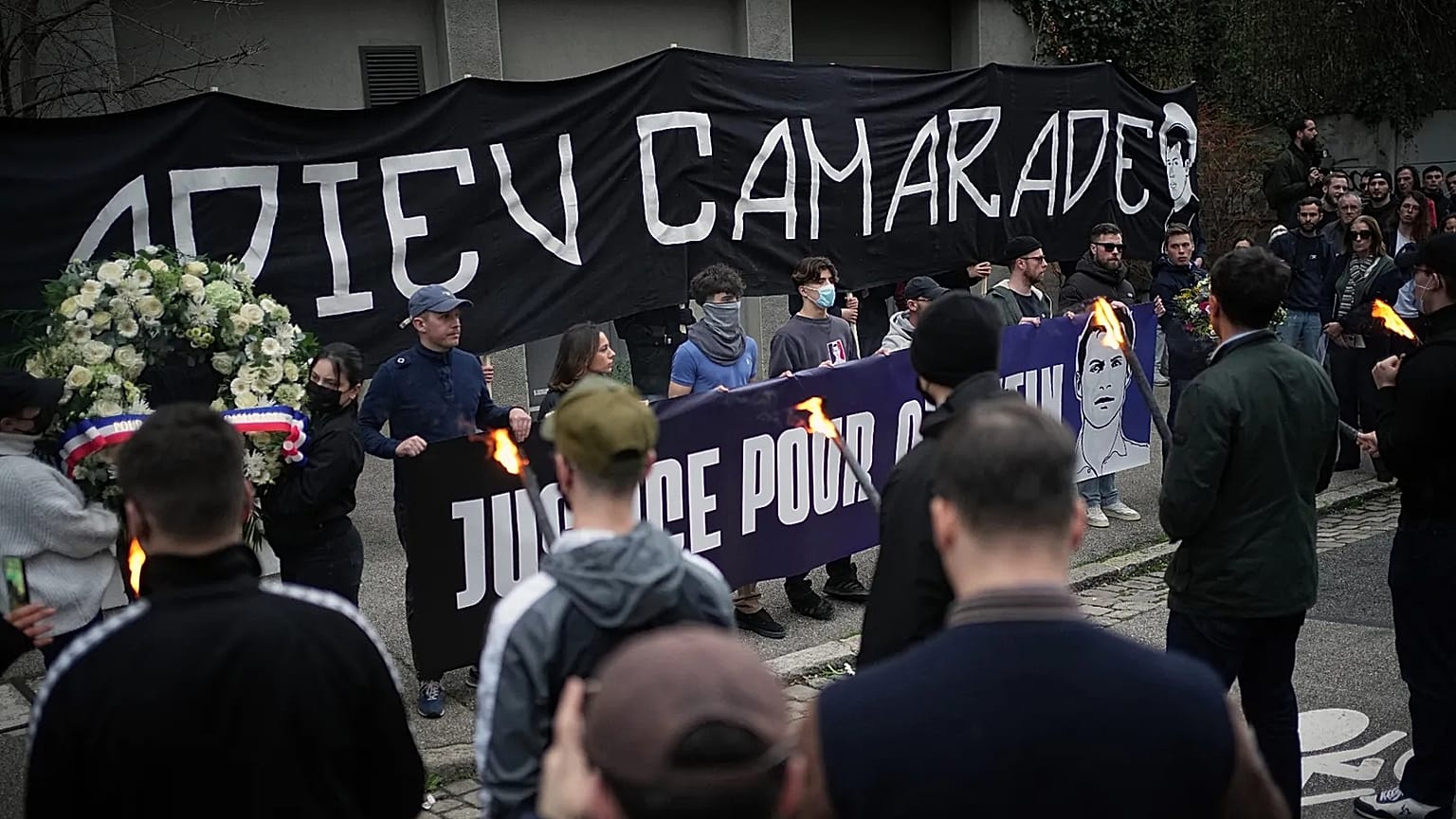 People hold up a banner reading "Au revoir camarade" during a march in Lyon, France, on Saturday 21 February 2026, 