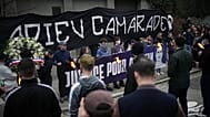 People hold up a banner reading "Au revoir camarade" during a march in Lyon, France, on Saturday 21 February 2026, 
