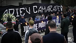 People hold up a banner reading "Au revoir camarade" during a march in Lyon, France, on Saturday 21 February 2026, 