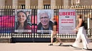 FILE - People walk past the portraits of French nationals Cecile Kohler and Jacques Paris in front of the French National Assembly in Paris, 3 July 2025