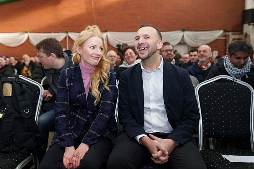 Green Party leader Zack Polanski, right, sits with the party candidate is the Gorton and Denton by-election Hannah Spencer 