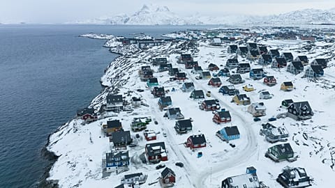 Houses are seen near the coast of a sea inlet of Nuuk, Greenland, on Saturday, Jan. 24, 2026.