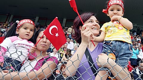 Turkish mothers hold their baby watching the celebrations of the National Sovereignty and Children's Festival  in 2008 in Ankara.
