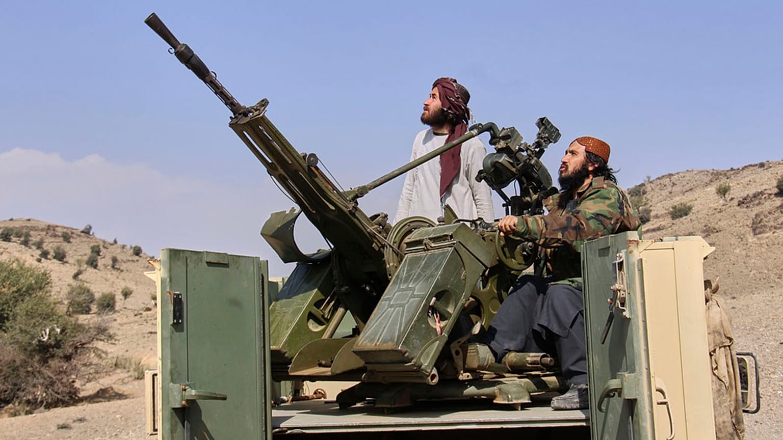 Taliban fighters look up while manning an armed pickup truck at the Afghan side of the Ghulam Khan crossing with Pakistan in Khost province, Afghanistan, 27 February 2026