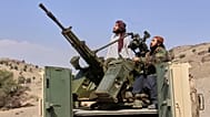 Taliban fighters look up while manning an armed pickup truck at the Afghan side of the Ghulam Khan crossing with Pakistan in Khost province, Afghanistan, 27 February 2026