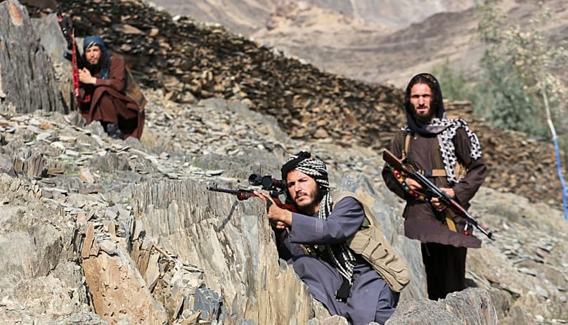 Afghan Taliban soldiers look toward the Pakistani side
