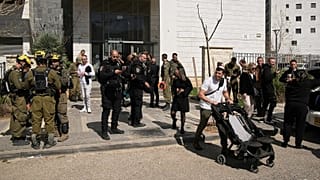 Residents are evacuated from a building hit by a projectile in Haifa, 28 February, 2026